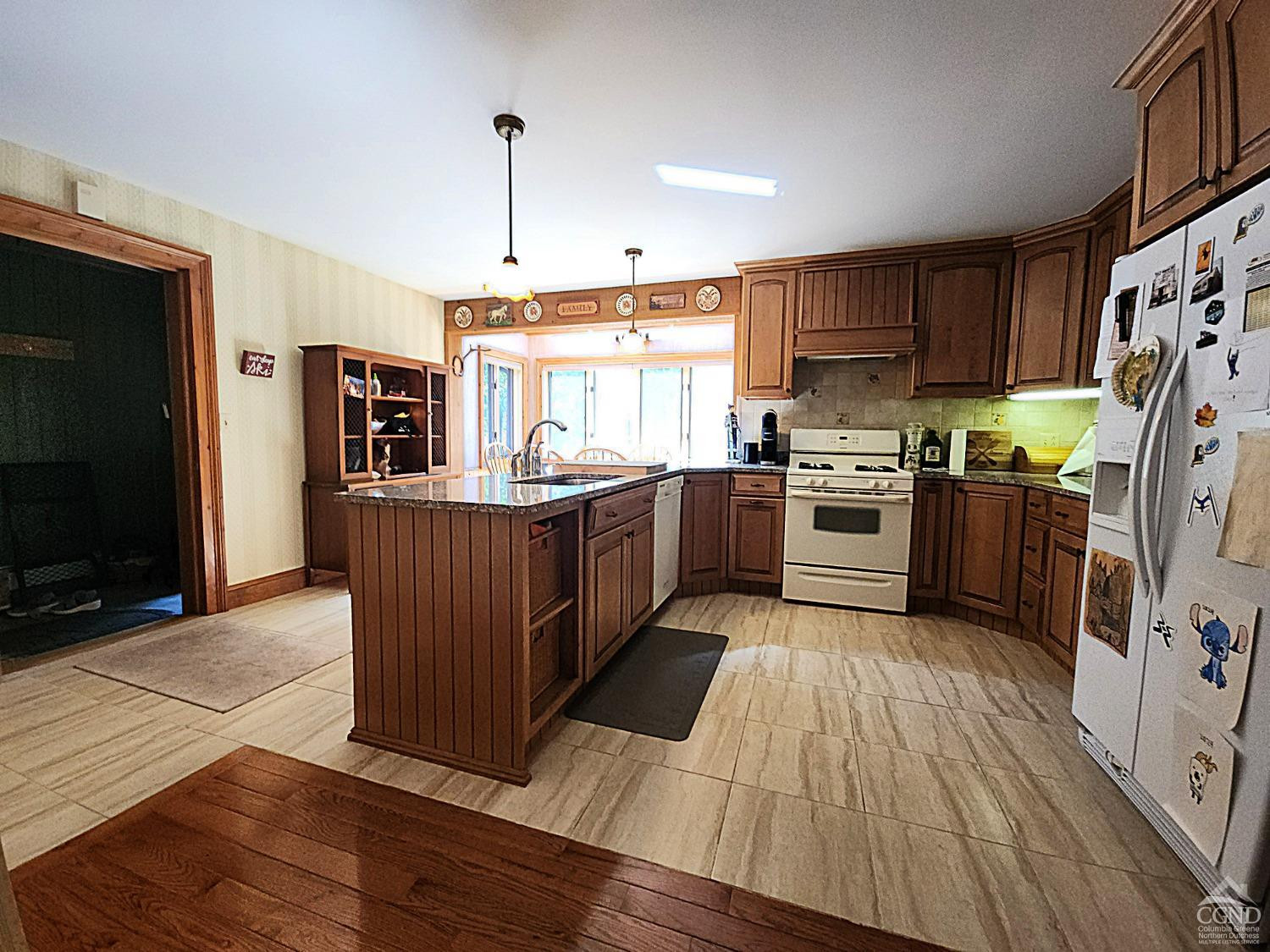 159 Toles Hollow Road Conesville, NY 12076 - Photo 16 of 53 a kitchen with stainless steel appliances granite countertop hardwood floor sink stove and refrigerator