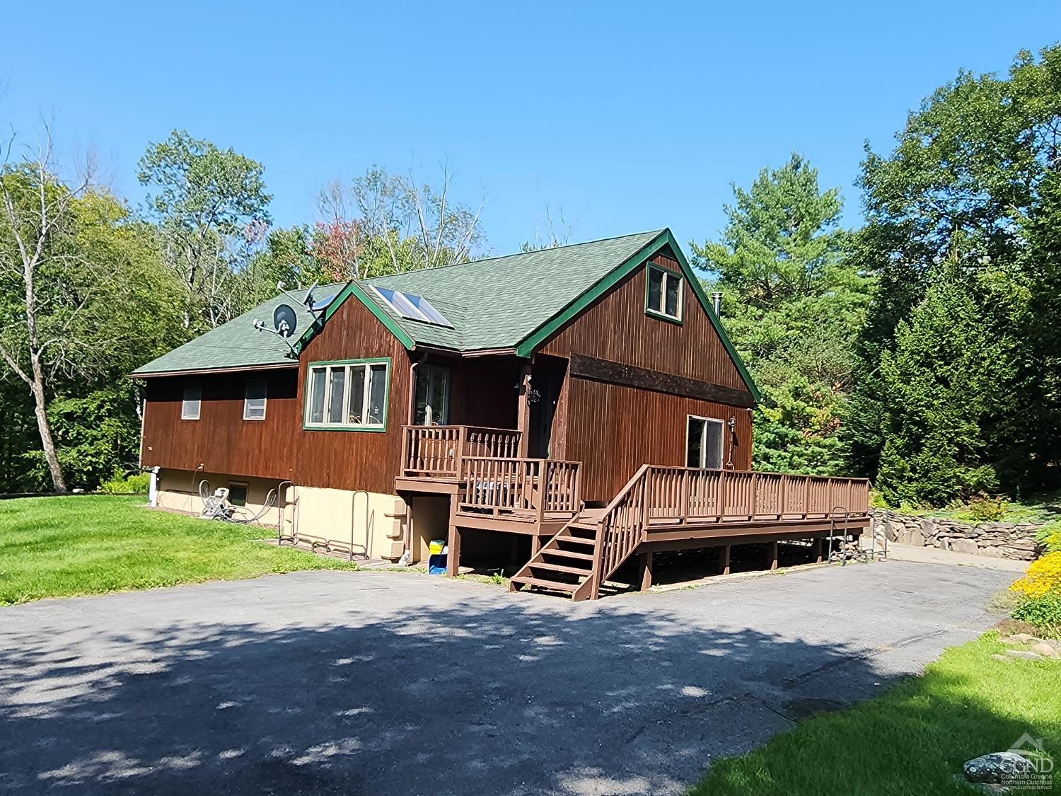 159 Toles Hollow Road Conesville, NY 12076 - Photo 2 of 53 a front view of a house with a yard and garage