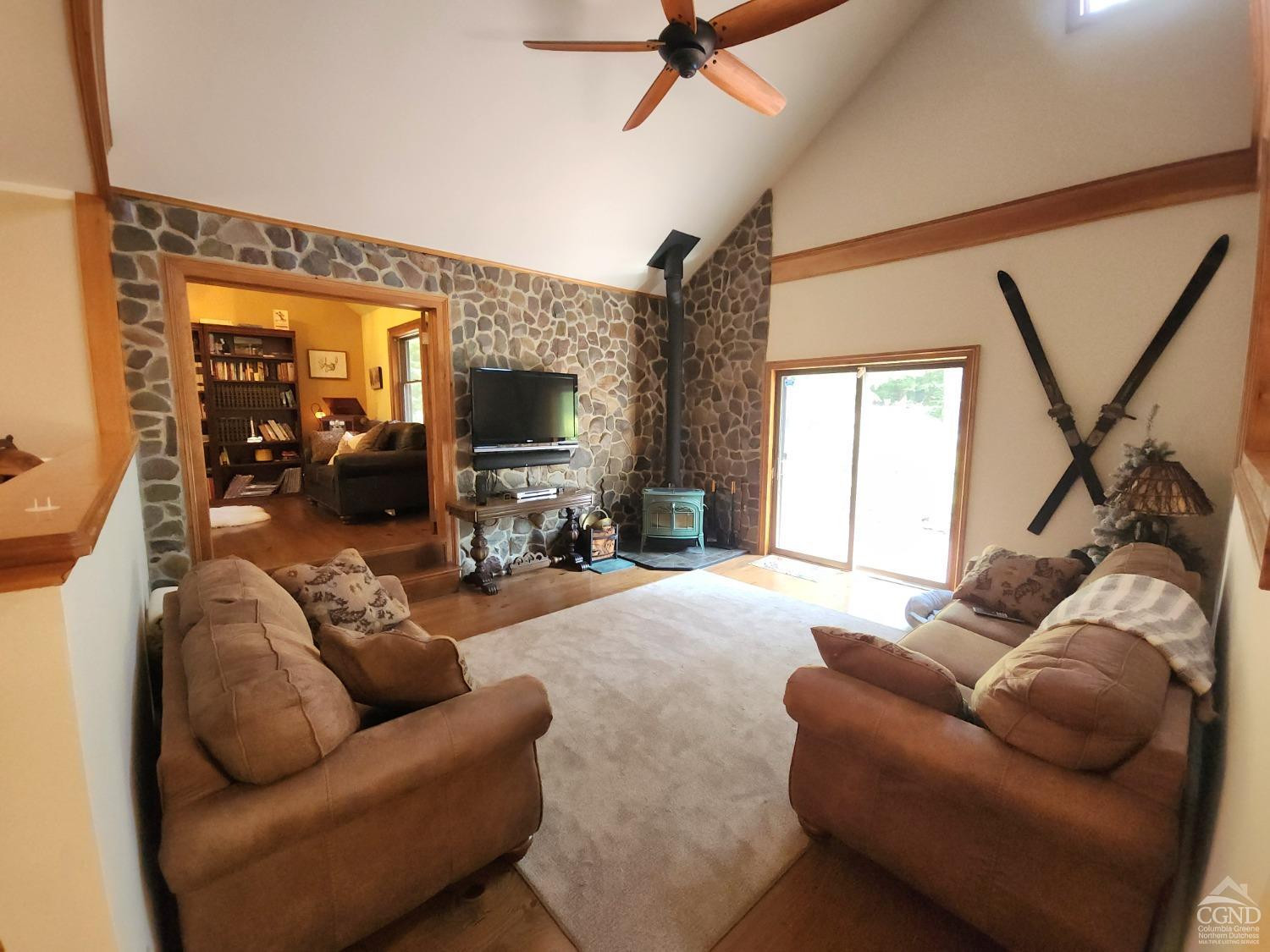 159 Toles Hollow Road Conesville, NY 12076 - Photo 21 of 53 a living room with furniture a large window and a flat screen tv