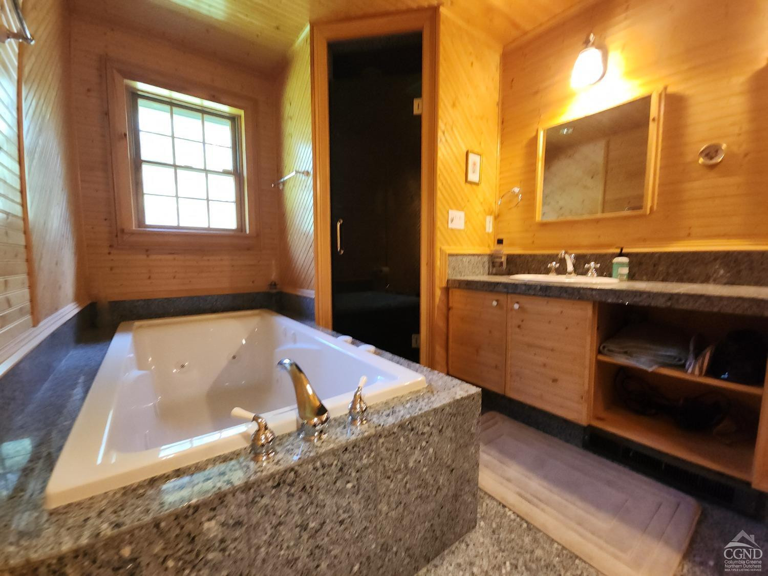 159 Toles Hollow Road Conesville, NY 12076 - Photo 30 of 53 a bathroom with a tub a sink and a large window