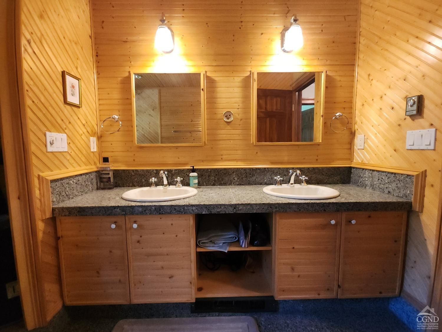 159 Toles Hollow Road Conesville, NY 12076 - Photo 31 of 53 a bathroom with a granite countertop sink and a mirror