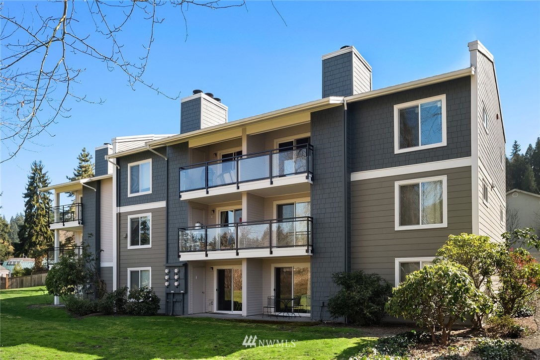 10838 East Riverside Drive, Unit C301 Bothell, WA 98011 - Photo 1 of 23 a front view of a building with garden