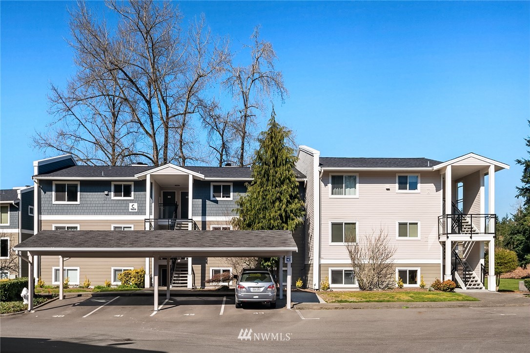 10838 East Riverside Drive, Unit C301 Bothell, WA 98011 - Photo 22 of 23 a front view of a house with a road