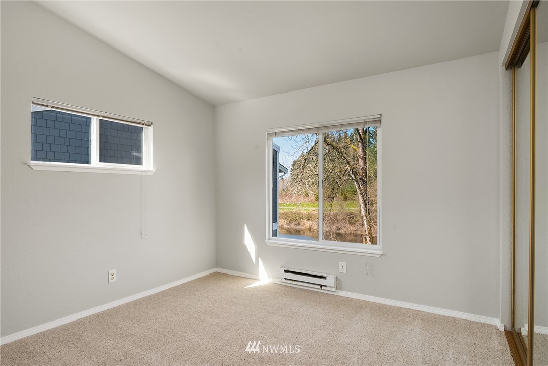 10838 East Riverside Drive, Unit C301 Bothell, WA 98011 - Photo 10 of 23 an empty room with windows