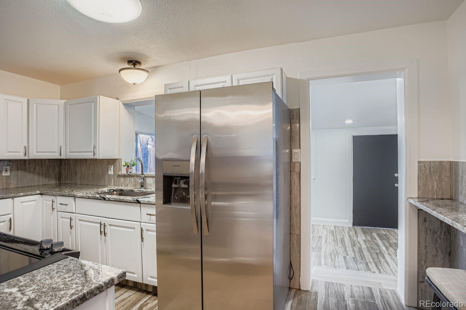 3822 Julian Street Denver, CO 80211 - Photo 11 of 28 a kitchen with a refrigerator and a sink