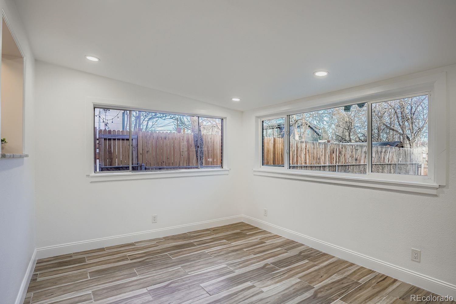 3822 Julian Street Denver, CO 80211 - Photo 14 of 28 a view of an empty room with a window and wooden floor