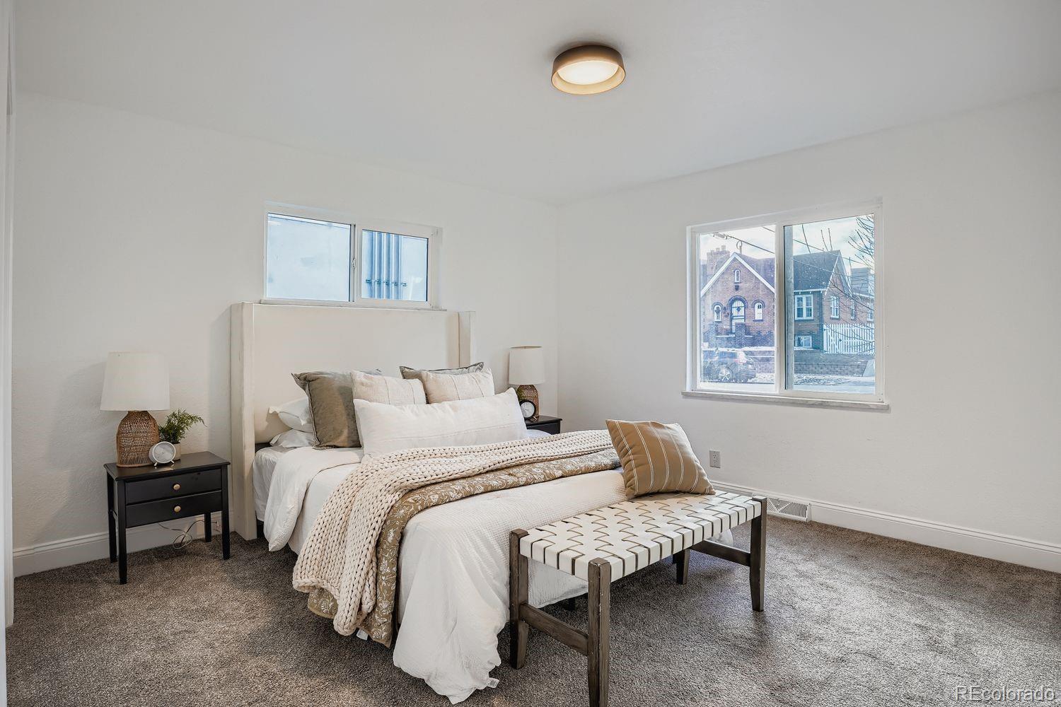 3822 Julian Street Denver, CO 80211 - Photo 17 of 28 a bedroom with a bed and a painting on the wall