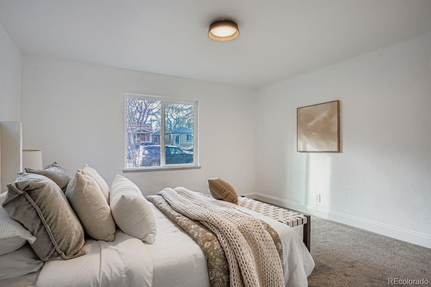 3822 Julian Street Denver, CO 80211 - Photo 18 of 28 a bedroom with bed and a window
