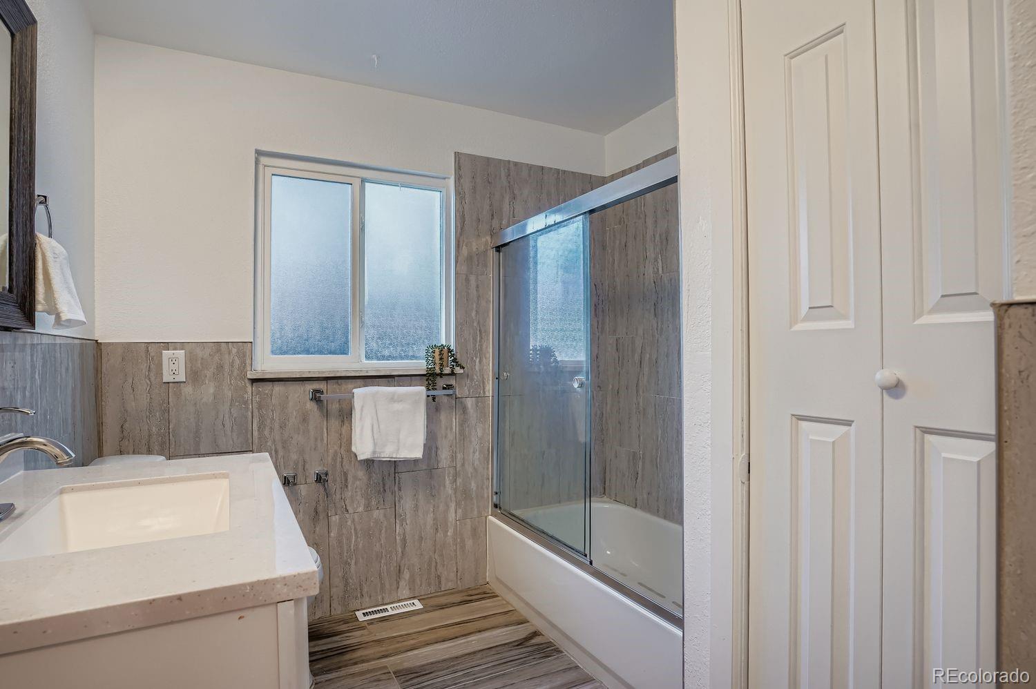 3822 Julian Street Denver, CO 80211 - Photo 19 of 28 a bathroom with a sink a toilet and shower