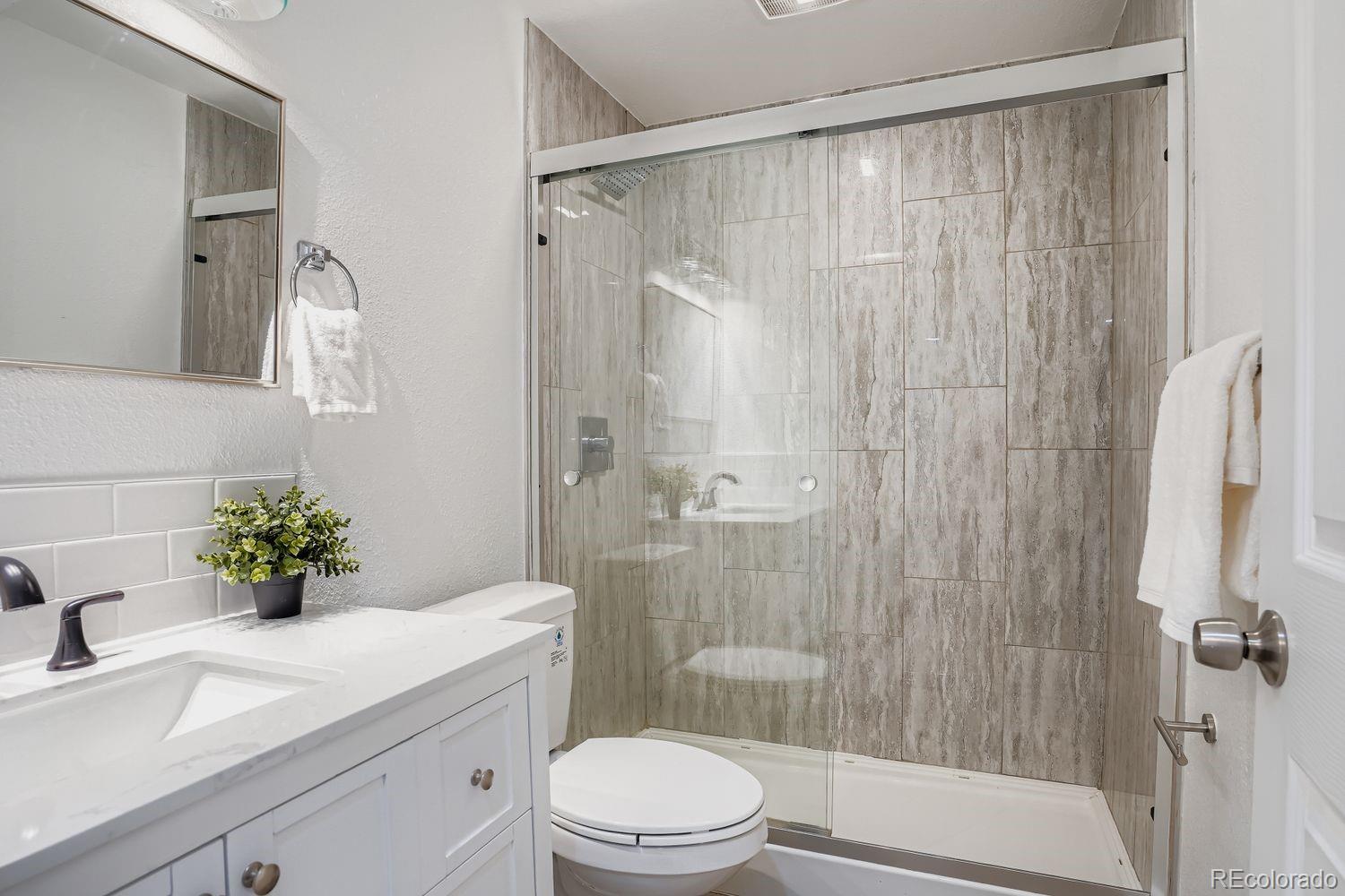 3822 Julian Street Denver, CO 80211 - Photo 23 of 28 a bathroom with a sink toilet and shower