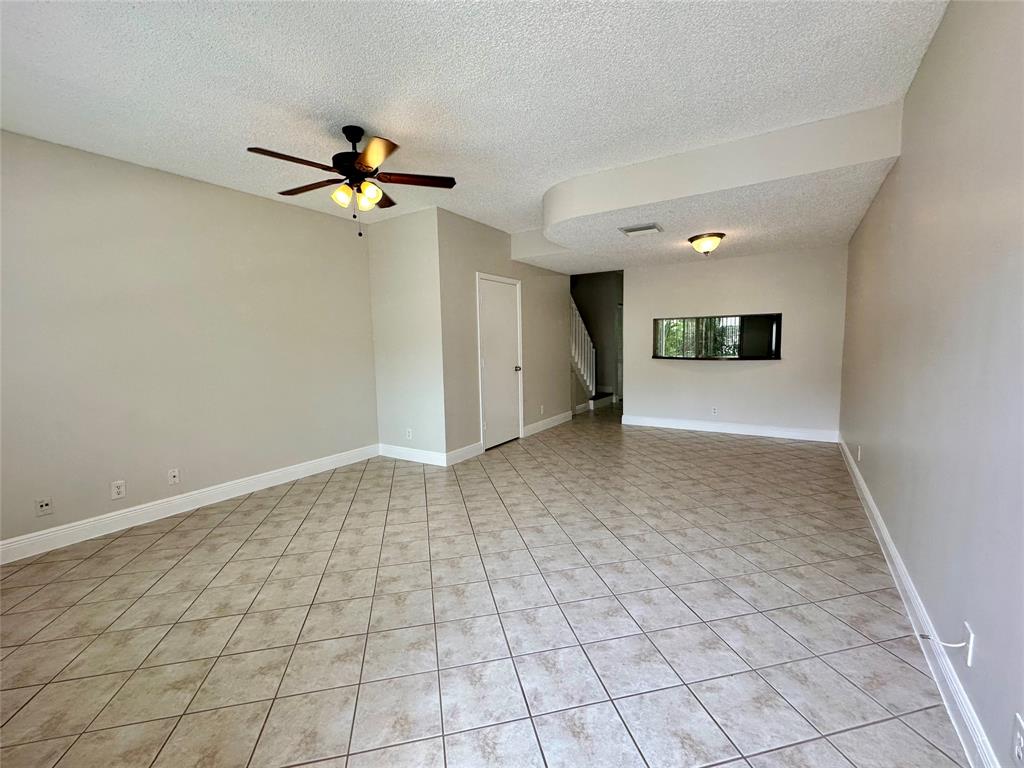 5660 Northwest 98th Way Coral Springs, FL 33076 - Photo 3 of 25 an empty room with windows and fan