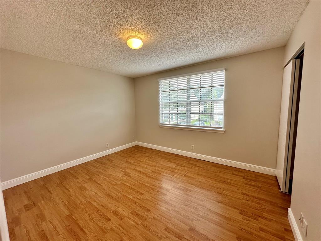 5660 Northwest 98th Way Coral Springs, FL 33076 - Photo 9 of 25 an empty room with wooden floor and windows