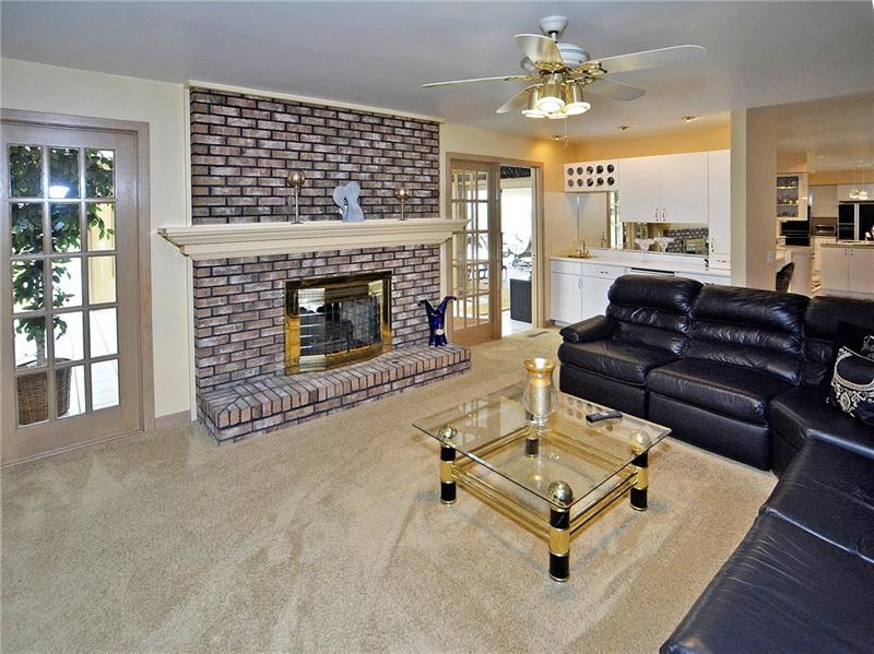 201 Harrison Road Turtle Creek, PA 15145 - Photo 7 of 25 Family room features a bar and doors to sunroom
