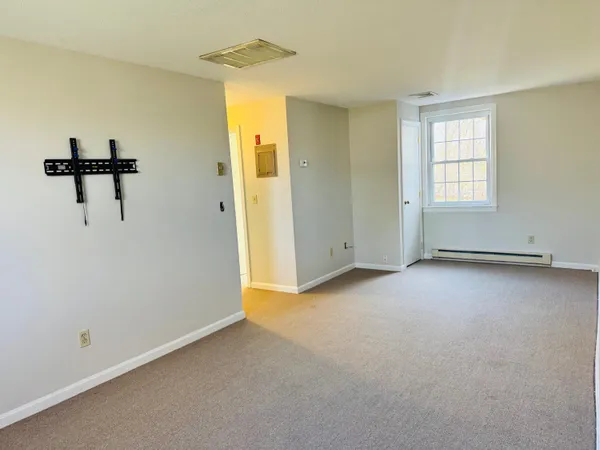 an empty room with windows and closet