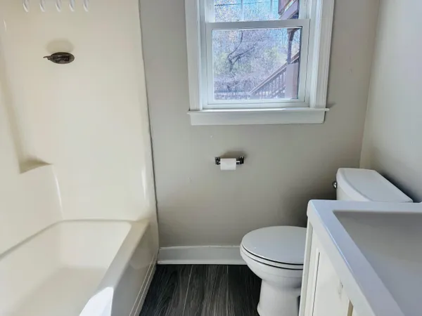 a bathroom with a toilet and a bathtub