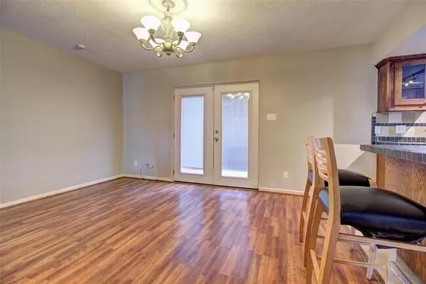 a view of a kitchen with stainless steel appliances wooden floor and a large window