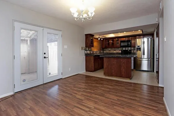 a kitchen with stainless steel appliances granite countertop a stove a sink dishwasher and a refrigerator
