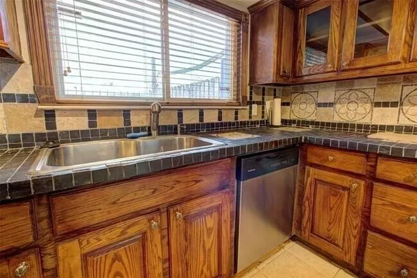 a kitchen with stainless steel appliances granite countertop a stove and a sink