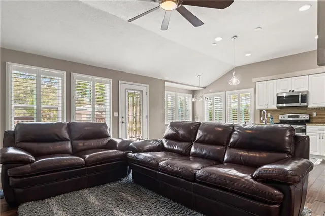 a living room with furniture a flat screen tv and a couch