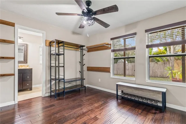 a bedroom with furniture window and wooden floor