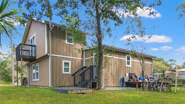 a view of a house with backyard porch and sitting area