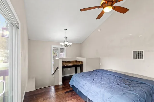 a bedroom with a bed and a chandelier