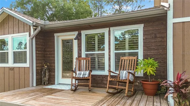 a view of a house with a porch and furniture