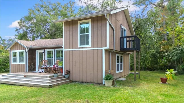a view of a house with a yard and sitting area
