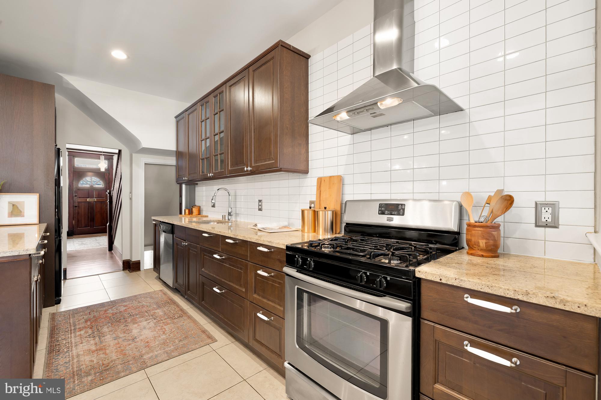 28 Bryant Street Northeast Washington, DC 20002 - Photo 14 of 41 a kitchen with granite countertop stainless steel appliances and wooden cabinets
