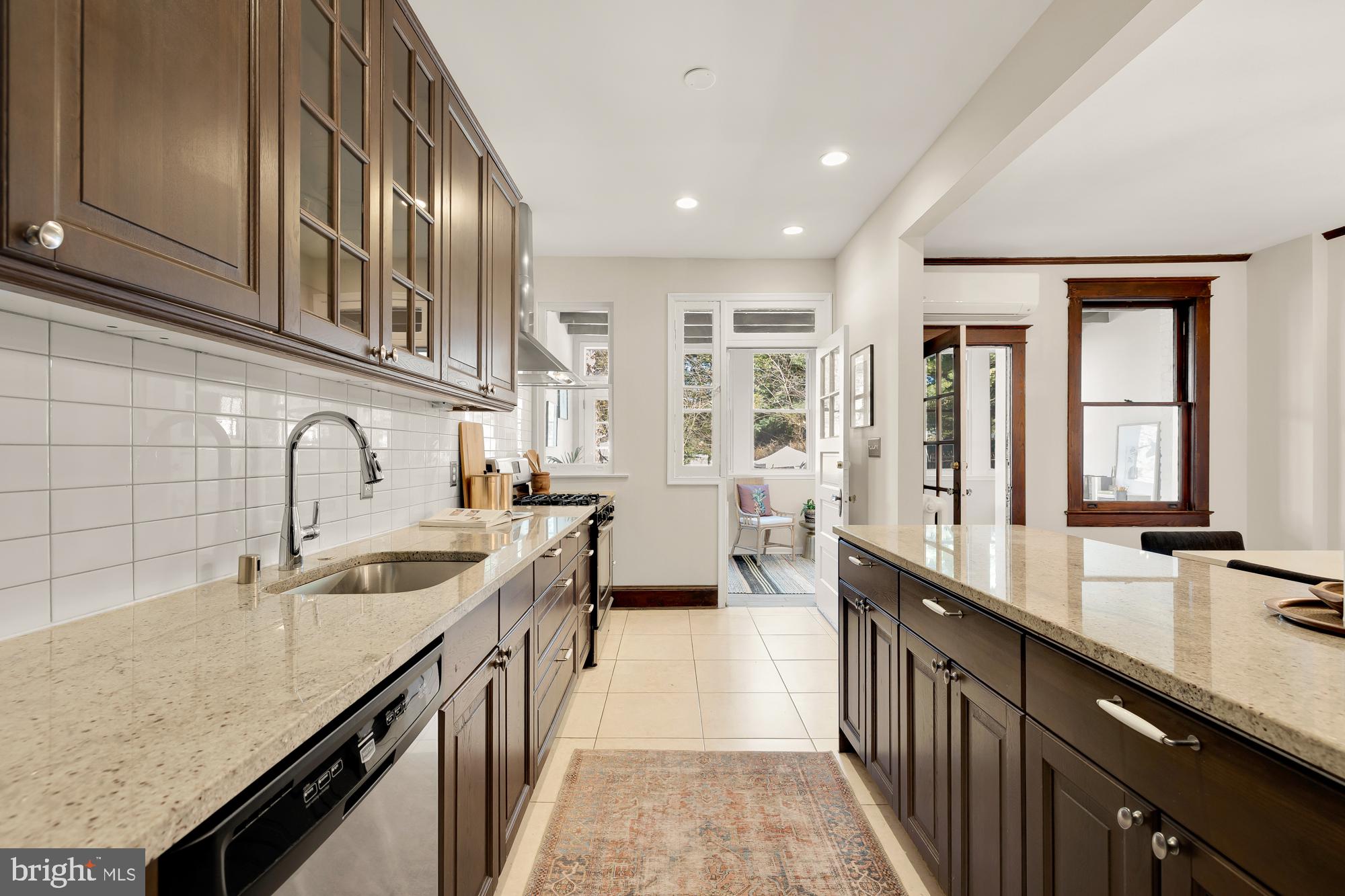 28 Bryant Street Northeast Washington, DC 20002 - Photo 16 of 41 a kitchen with granite countertop a sink and cabinets