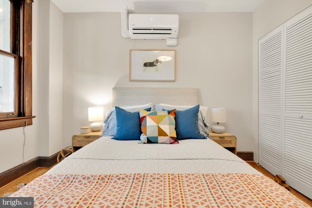 a bedroom with a bed and a window