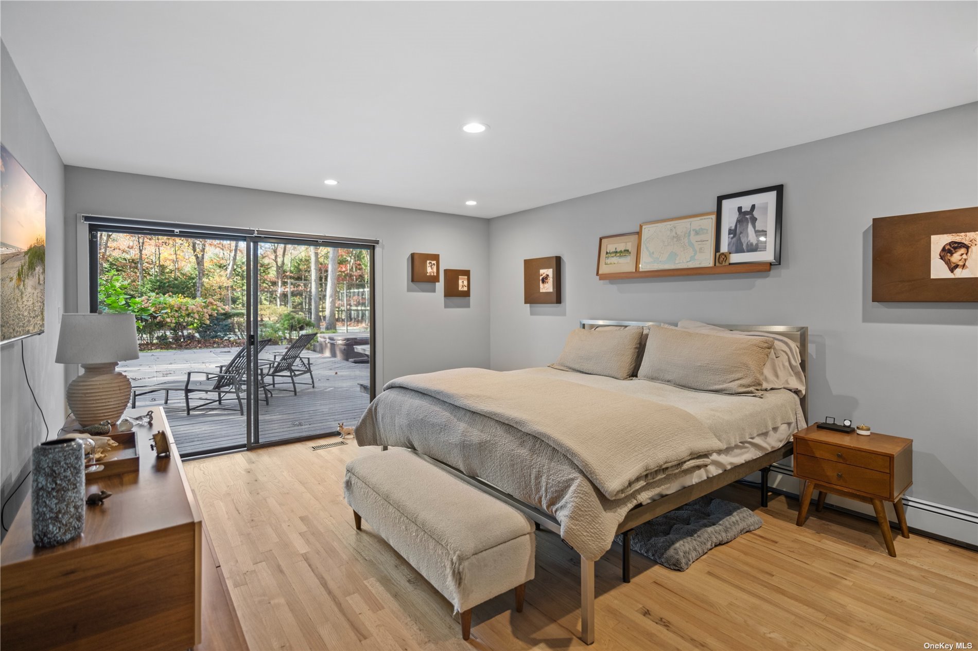 25 Westhampton, undefined 00000 - Photo 16 of 27 a spacious bedroom with a bed and a large window