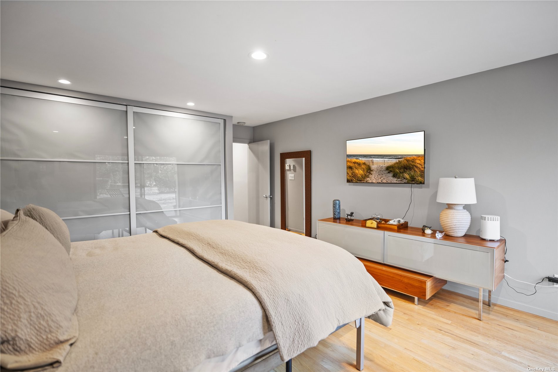 25 Westhampton, undefined 00000 - Photo 17 of 27 a bedroom with a bed and a table in it