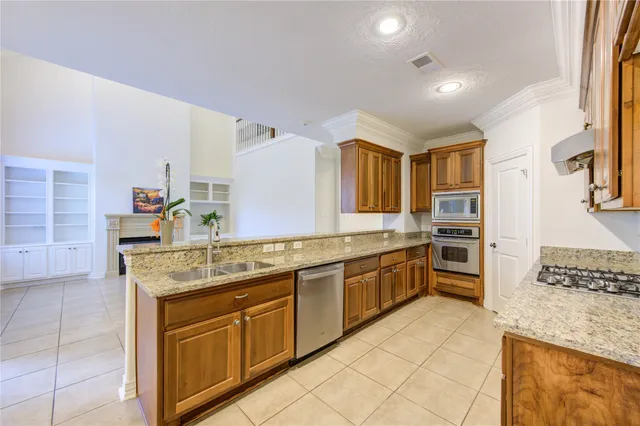 a kitchen with stainless steel appliances granite countertop a sink and cabinets