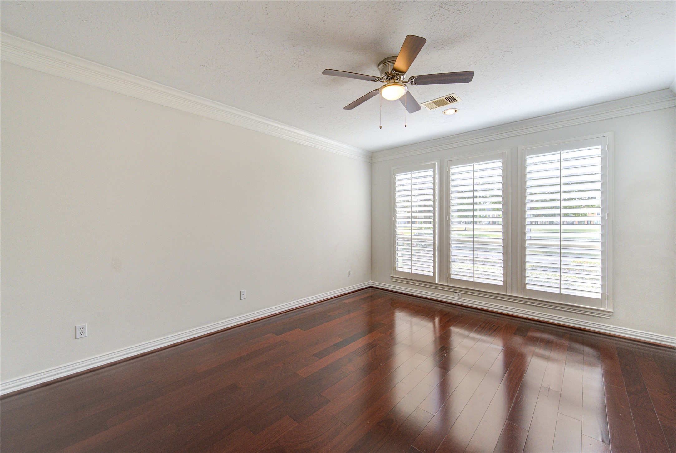 2011 Spring Cedar Lane Houston, TX 77077 - Photo 19 of 43 a view of an empty room with wooden floor and a window