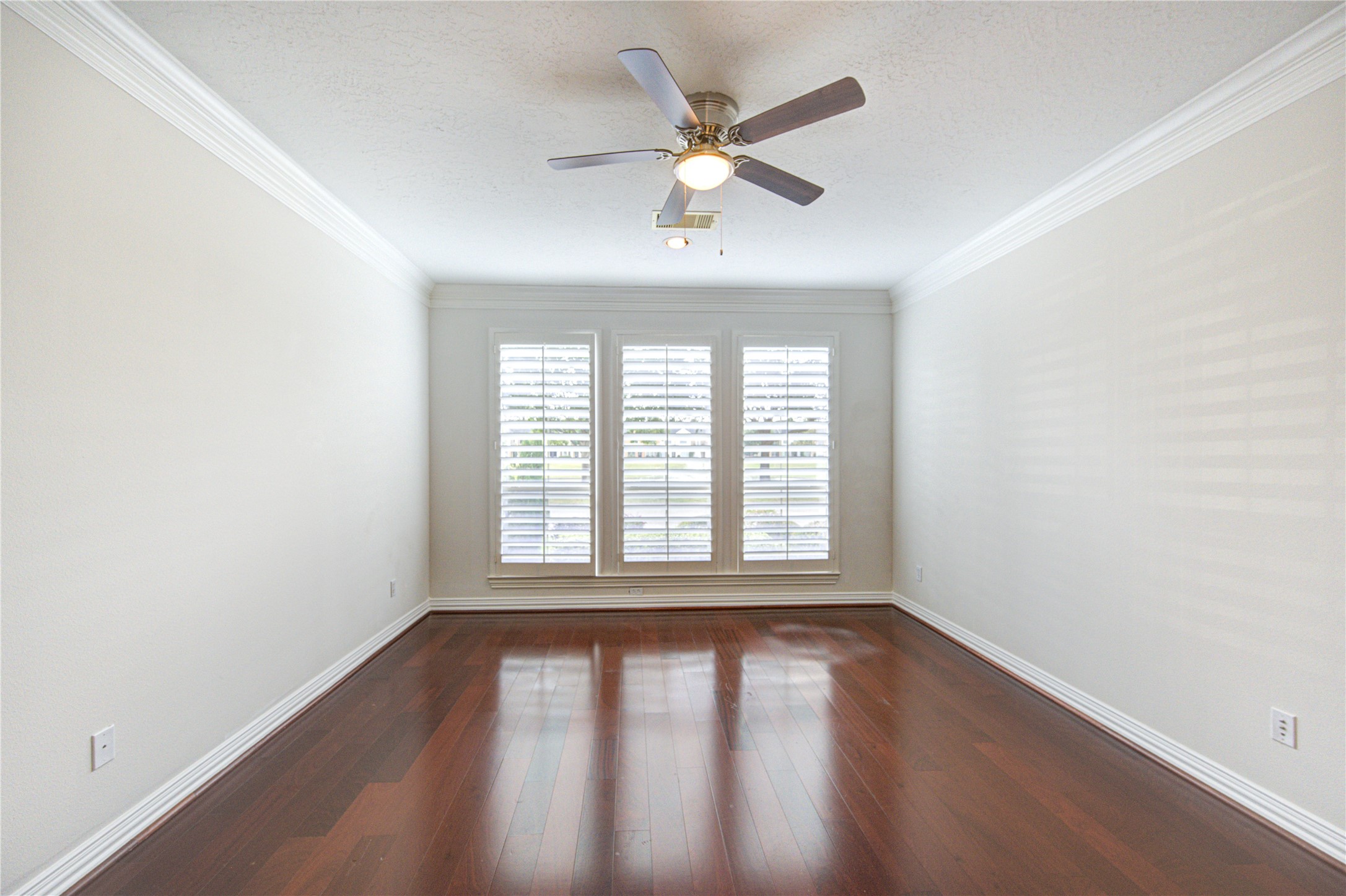 2011 Spring Cedar Lane Houston, TX 77077 - Photo 20 of 43 an empty room with wooden floor windows and ceiling fan