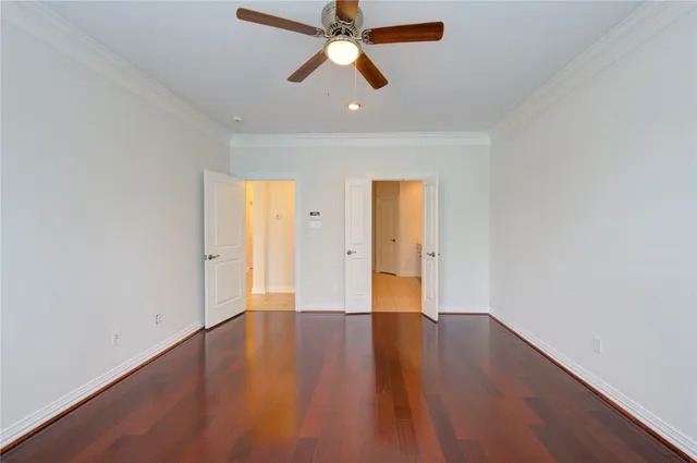 an empty room with wooden floor a ceiling fan and closet