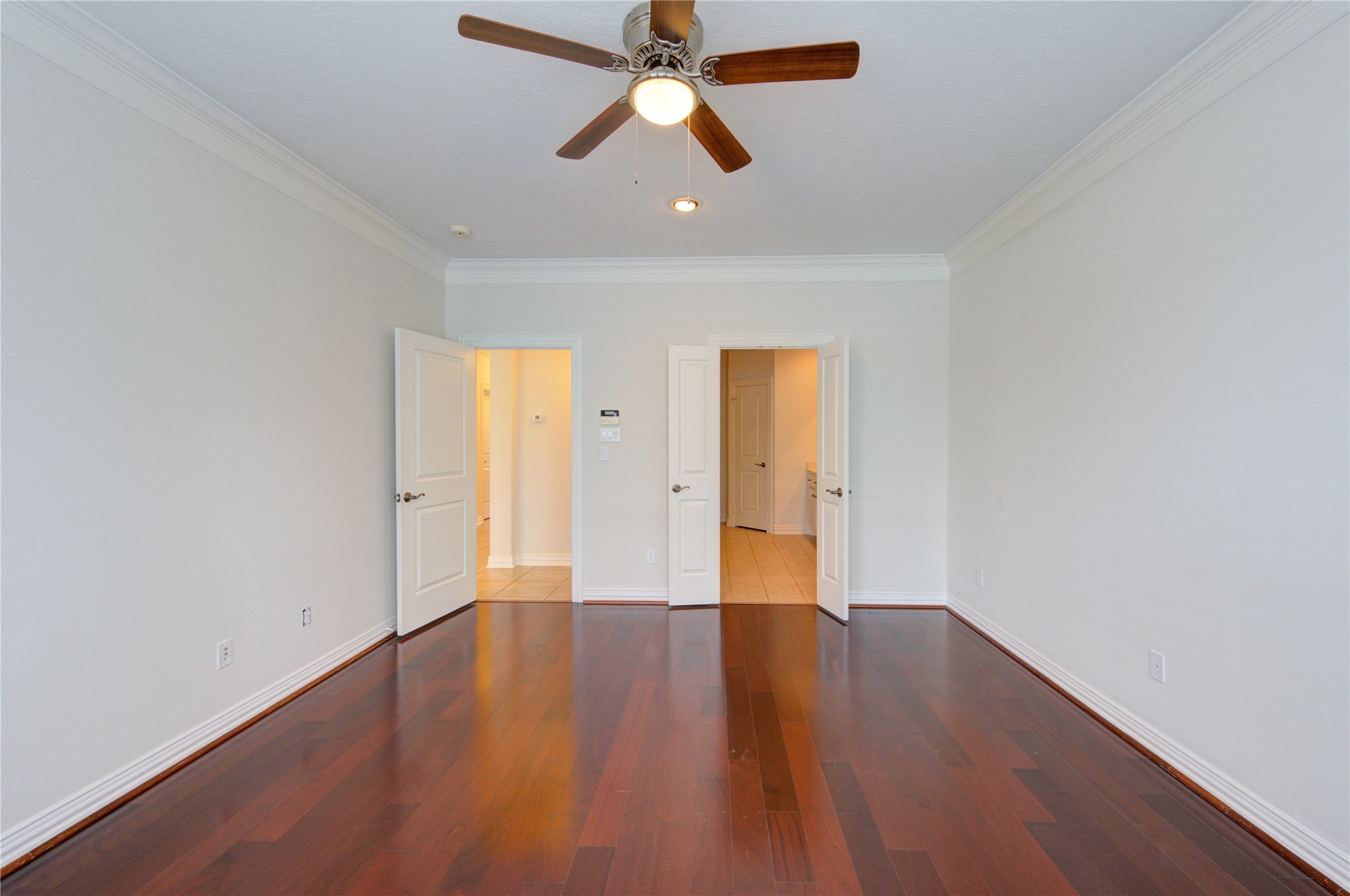2011 Spring Cedar Lane Houston, TX 77077 - Photo 21 of 43 an empty room with wooden floor a ceiling fan and closet