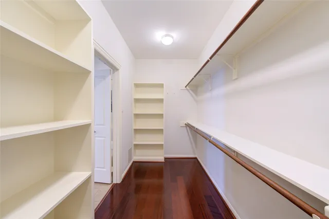 a view of hallway with stairs and wooden floor