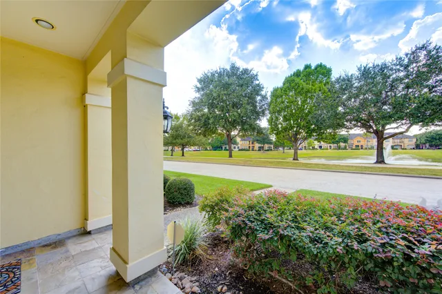 a view of a garden with large trees