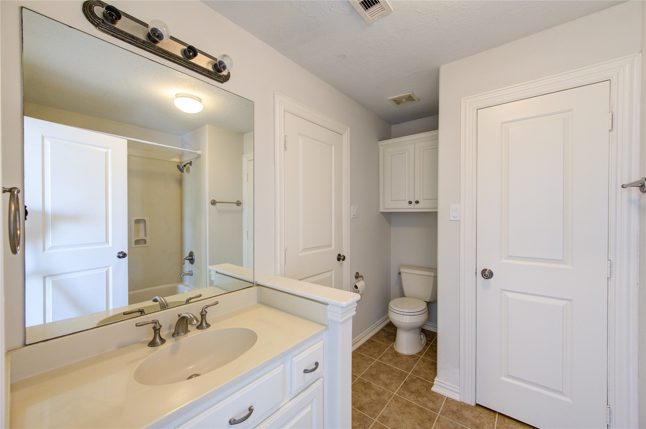 2011 Spring Cedar Lane Houston, TX 77077 - Photo 38 of 43 a bathroom with a sink a toilet a shower and a mirror