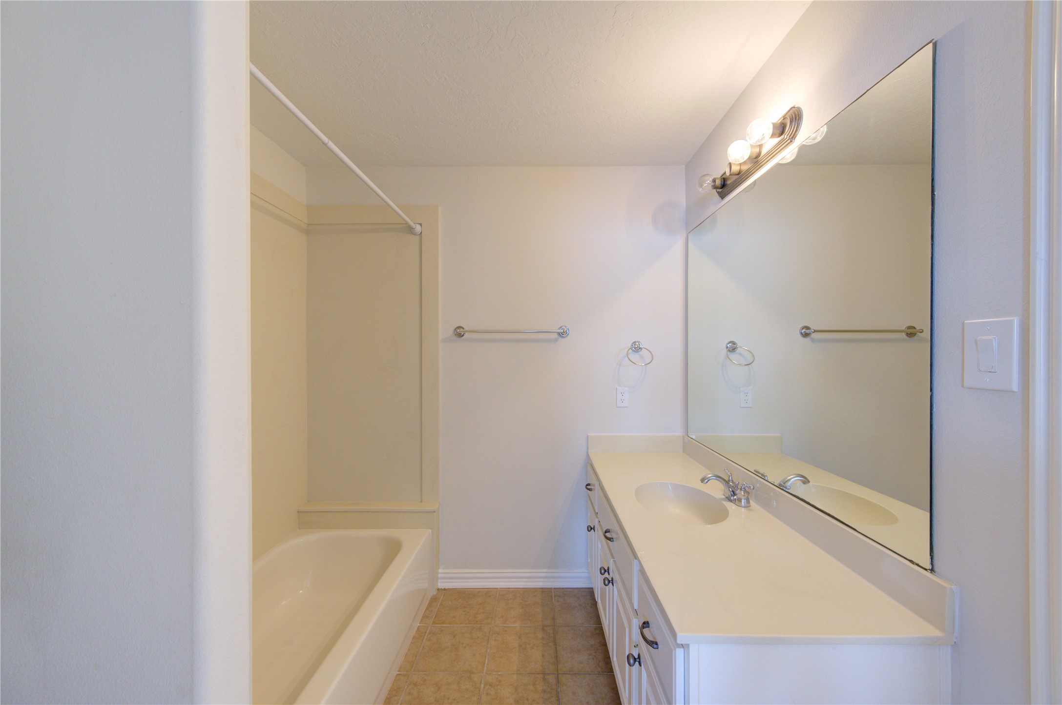 2011 Spring Cedar Lane Houston, TX 77077 - Photo 40 of 43 a bathroom with a tub sink and mirror