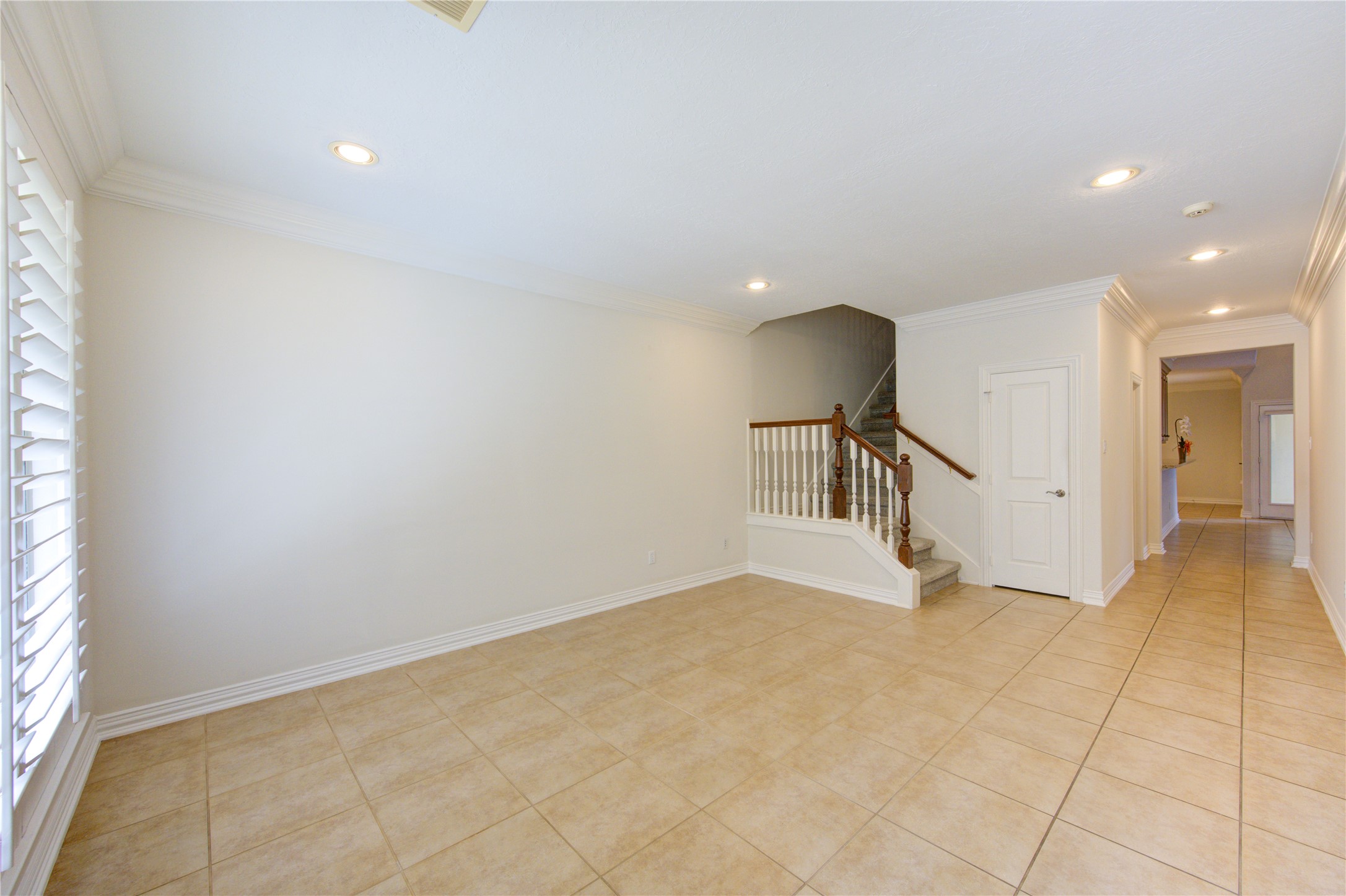 2011 Spring Cedar Lane Houston, TX 77077 - Photo 7 of 43 a view of an empty room with wooden floor and a window