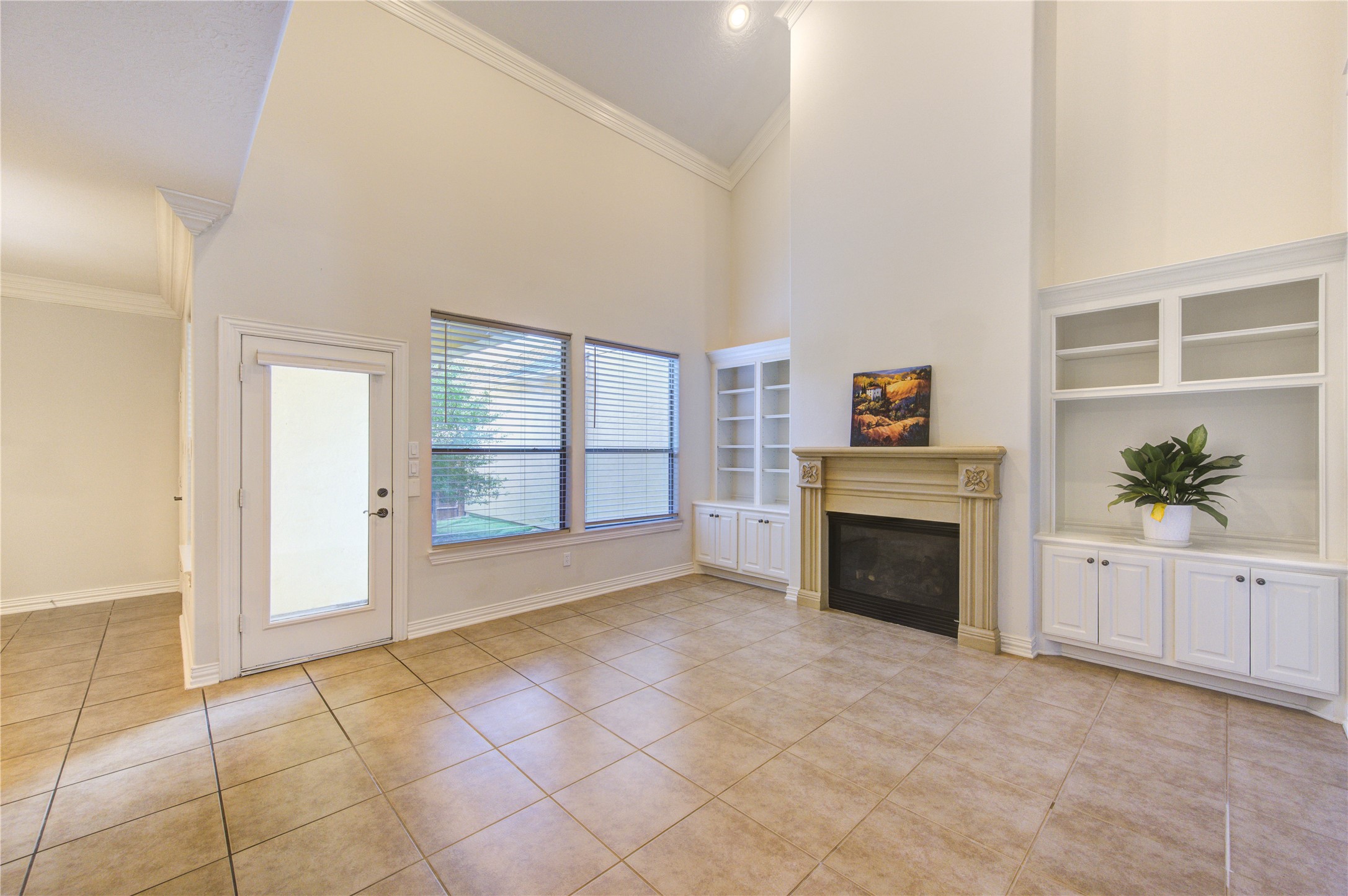 2011 Spring Cedar Lane Houston, TX 77077 - Photo 10 of 43 an empty room with windows and fireplace