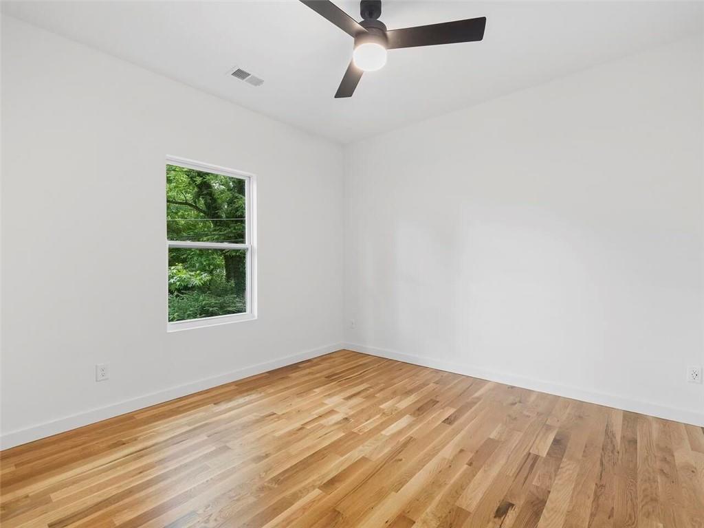 1065 Hubbard Street Southwest Atlanta, GA 30310 - Photo 15 of 20 an empty room with wooden floor and windows