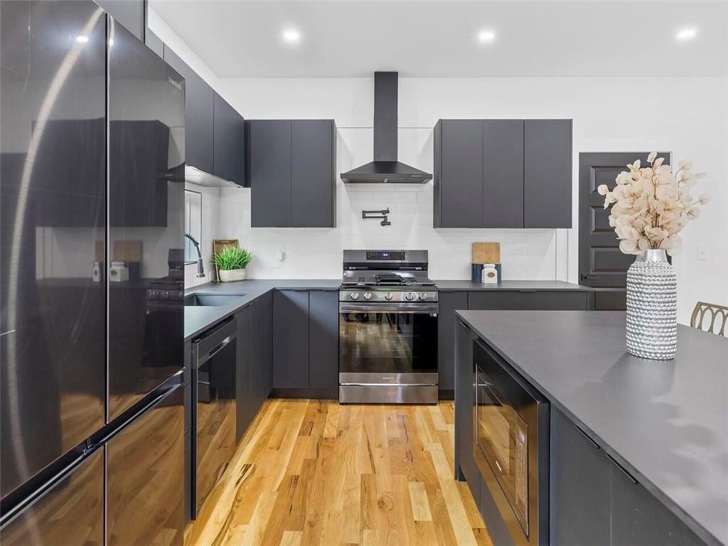 1065 Hubbard Street Southwest Atlanta, GA 30310 - Photo 7 of 20 a kitchen with stainless steel appliances granite countertop a sink a stove and a refrigerator