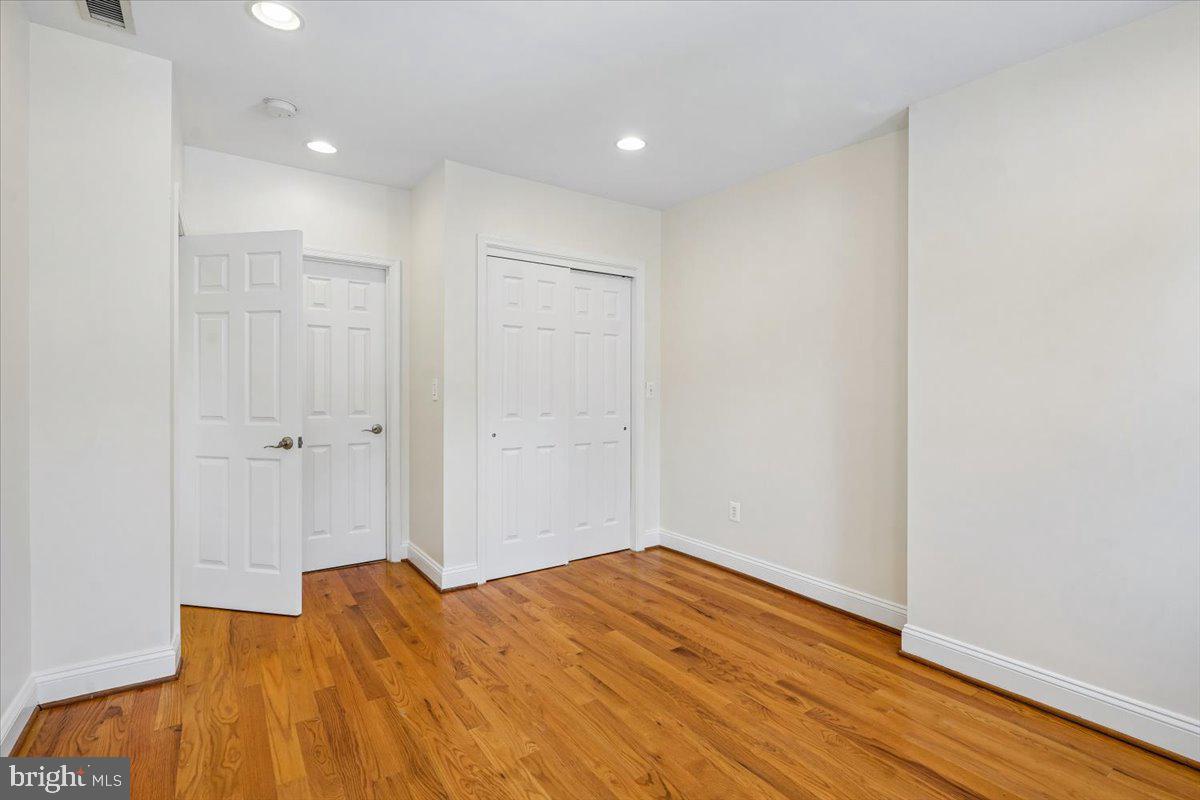 1339 C Street Northeast Washington, DC 20002 - Photo 13 of 24 a view of a bedroom with wooden floor and a bathroom