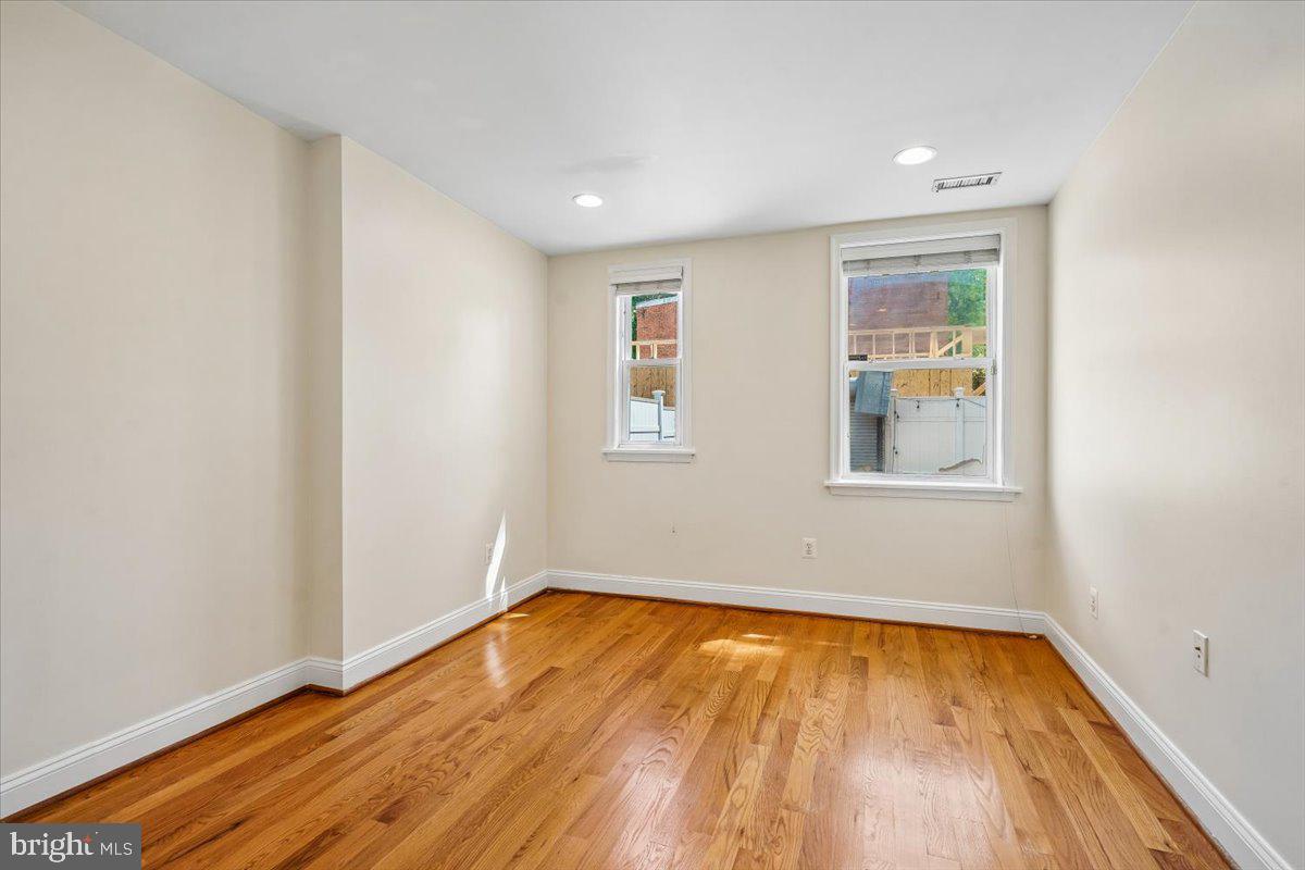 1339 C Street Northeast Washington, DC 20002 - Photo 14 of 24 a view of empty room with wooden floor and fan
