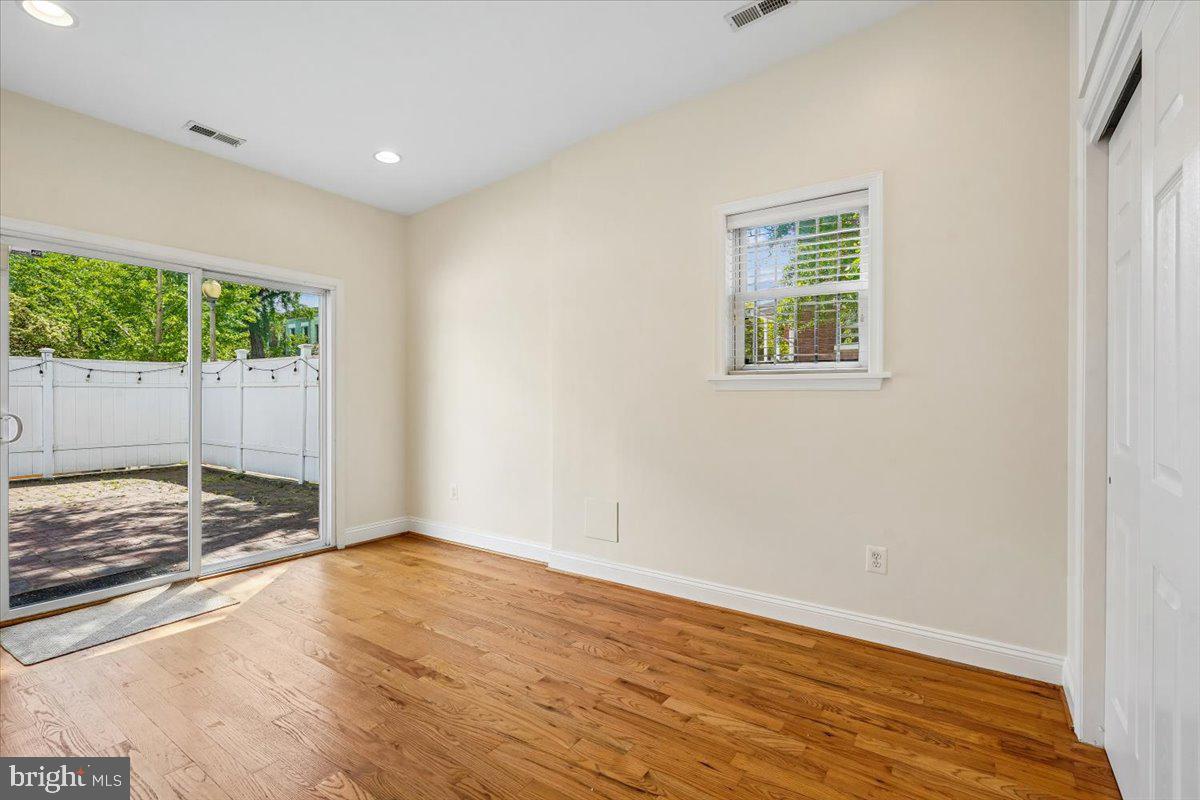 1339 C Street Northeast Washington, DC 20002 - Photo 18 of 24 a view of empty room with wooden floor and fan
