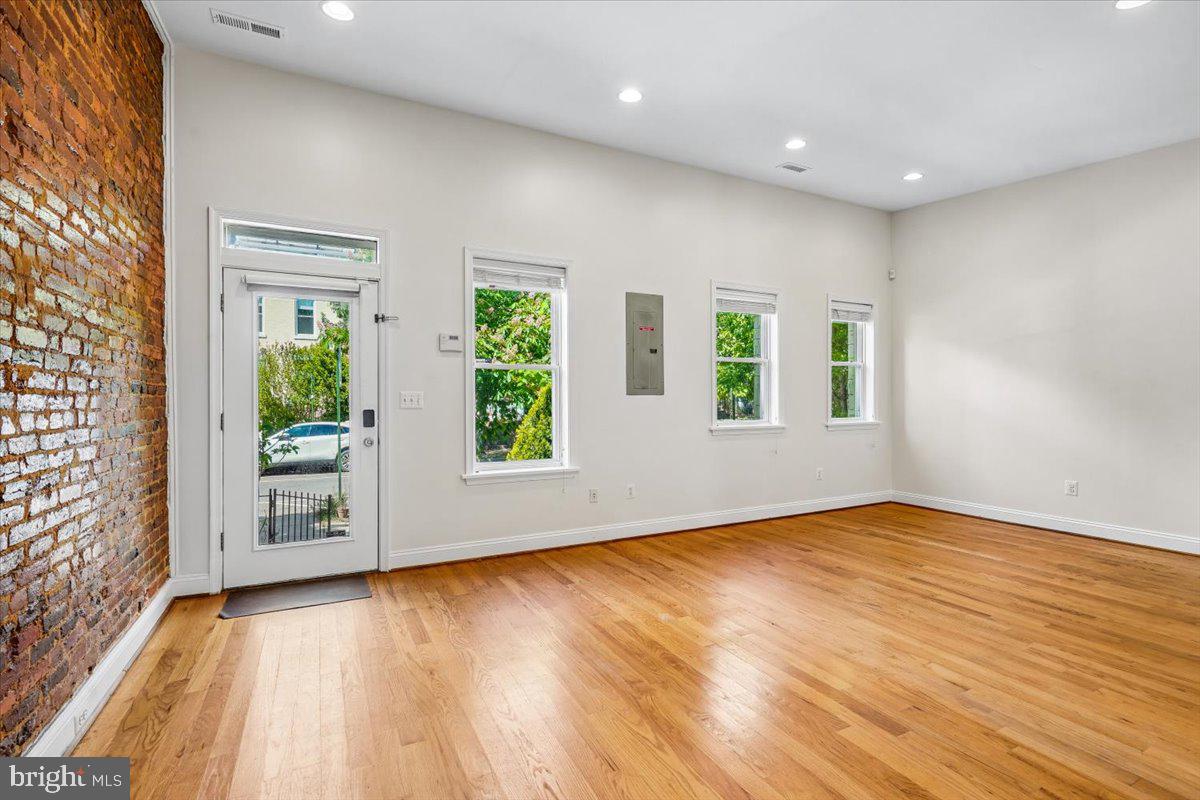 1339 C Street Northeast Washington, DC 20002 - Photo 3 of 24 an empty room with wooden floor and windows